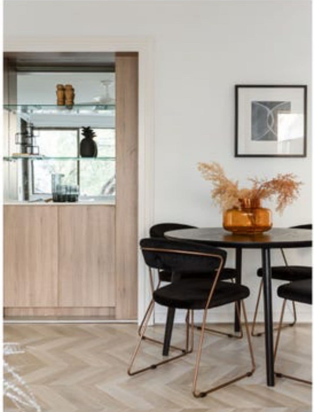 Renovated dining nook with chevron timber floors and custom oak joinery by Reno Build in Sydney